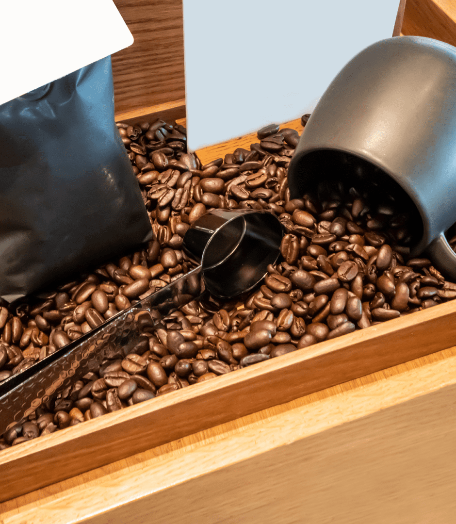Coffee beans with black scoop and mug